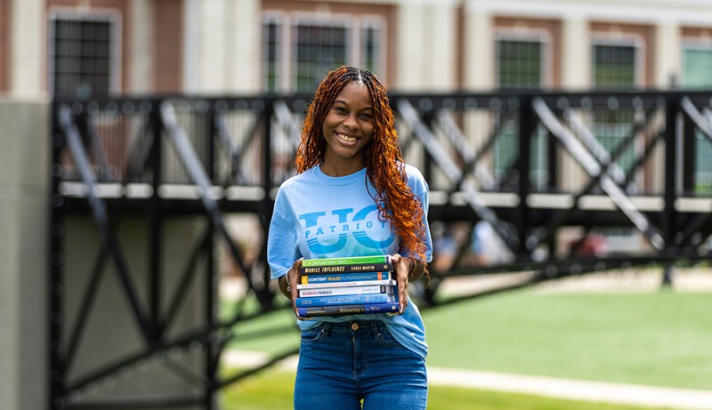 girl holding textbooks