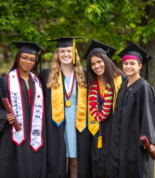 Four wrestlers pose after graduation