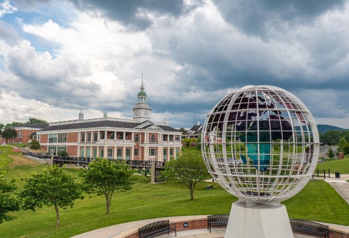 Large globe statue in front of campus building