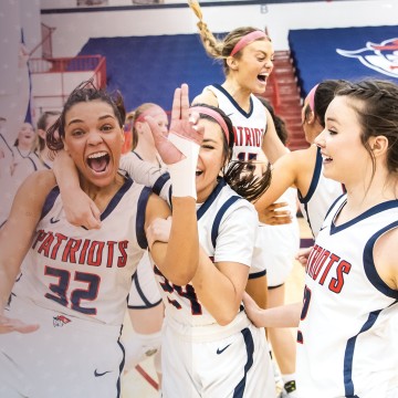 Students on the women's basketball team celebrate following a win. 
