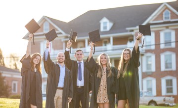 Students share a moment as they prepare for graduation. 