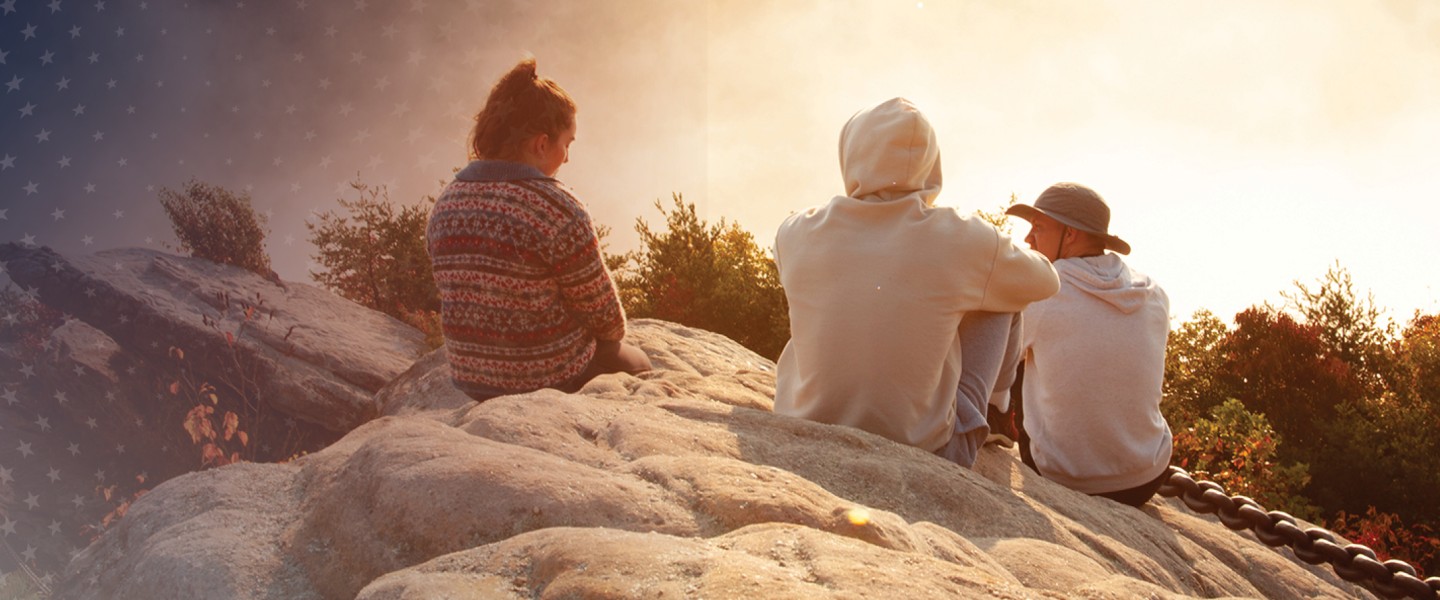 Students watch a sunrise from Chain Rock near campus. 