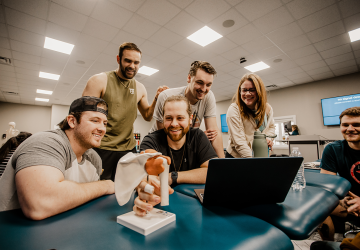 Physical therapy students conduct an anatomy exercise in class. 