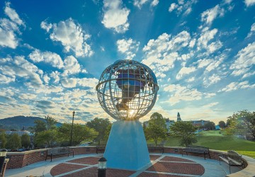 The sun rises behind the globe statue on Cumberlands' campus. 