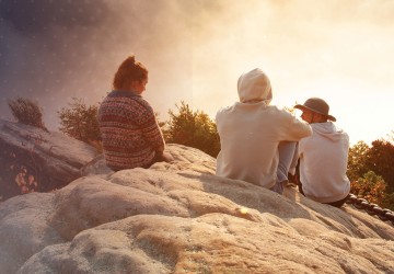 Students watch a sunrise from Chain Rock near campus. 