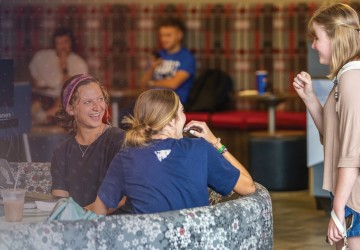Students laugh while hanging out in the campus student center. 