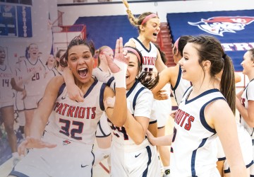 Students on the women's basketball team celebrate following a win. 