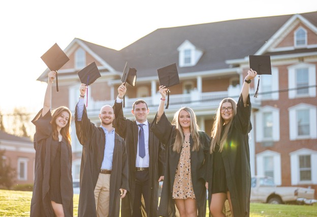 Students share a moment as they prepare for graduation. 